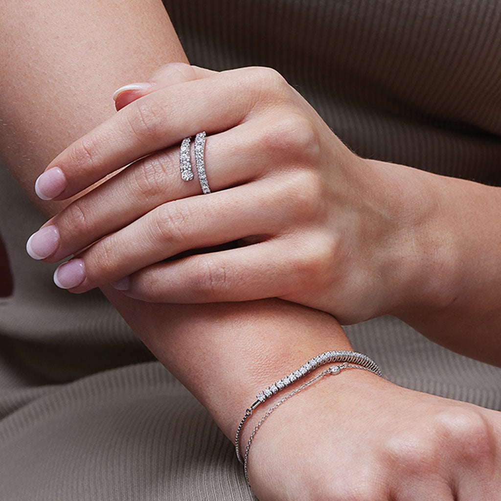 Sculptural swirl bypass diamond ring on hand