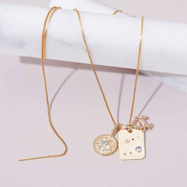 Cancer zodiac necklace with aquamarine birthstone and con pattern in gold