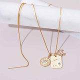 Constellation charm necklaces with diamonds and birthstones styled together in gold