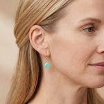 Handmade chalcedony earrings shown on model. variant--Gold-fill variant--Rose-Gold-fill variant--Sterling-silver variant--Oxidized-sterling-silver variant--14K-yellow-gold variant--14K-white-gold variant--14K-rose-gold variant--Chalcedony