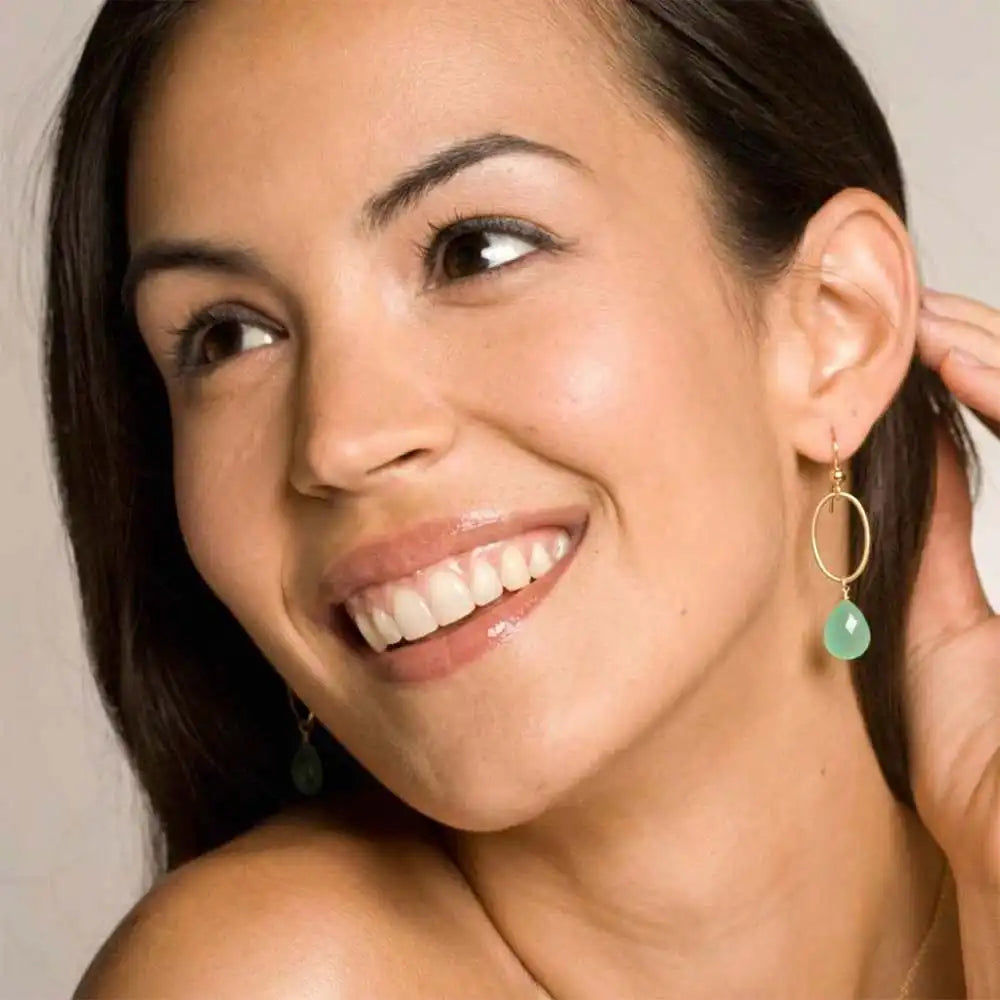 Woman wearing small faceted chrysoprase hoop earrings in yellow gold fill, vivid apple-green gemstone with bright grassy glow, lifestyle portrait. all-groups