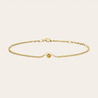 Bezel-set citrine bracelet flatlay showing warm golden stone on curb chain