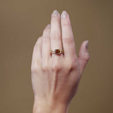 Citrine cocktail ring on model's hand, warm amber emerald-cut stone in yellow gold