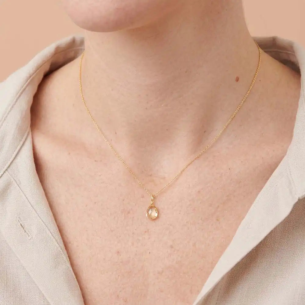 Warm yellow citrine pendant necklace with refined silhouette on model