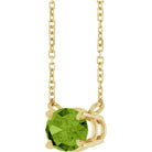 Horizontal-set peridot birthstone necklace in gold setting close up