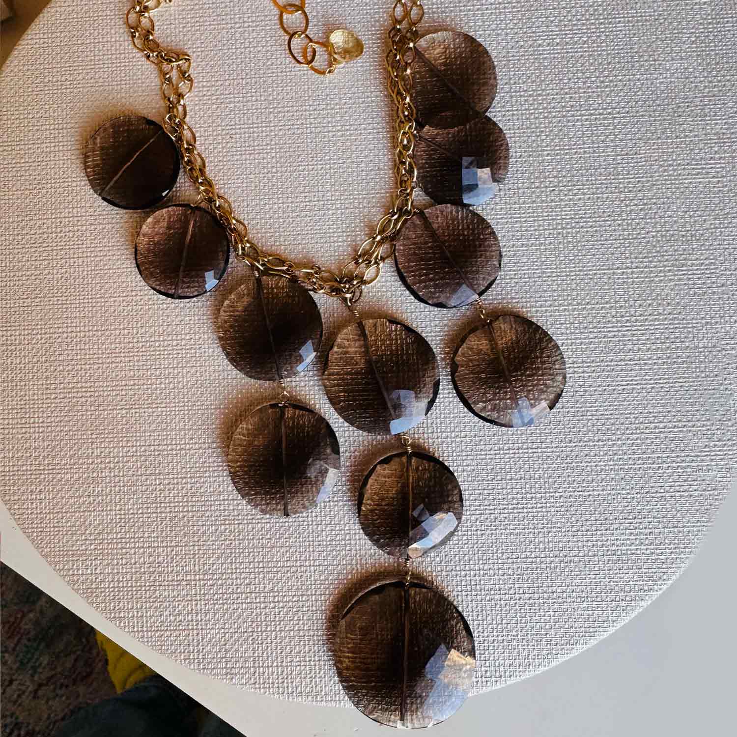Gemstone bib necklace with cascading faceted smokey topaz discs on 14K gold-fill chain