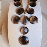 Smokey topaz bib necklace close-up showing faceted gemstone disc detail