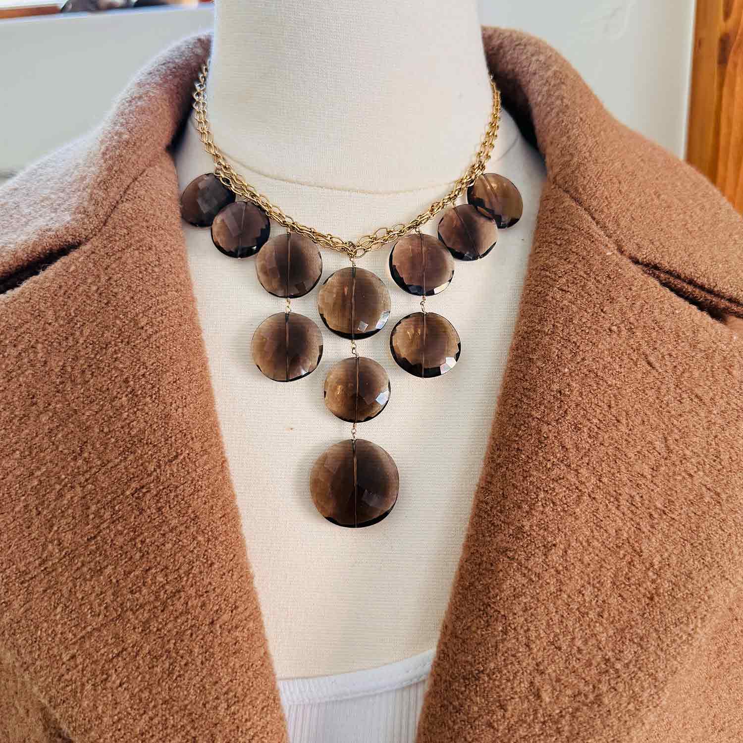 Gemstone bib necklace with smokey topaz discs worn on model