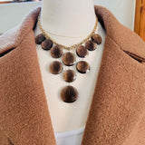 Gemstone bib necklace with smokey topaz discs worn on model