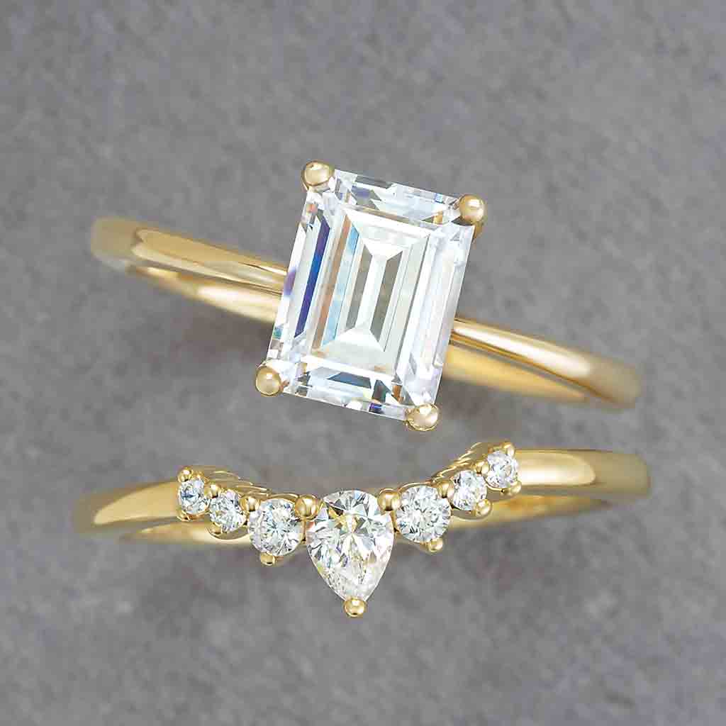 Contour diamond band in 14K yellow gold with pear and round diamonds styled with engagement ring