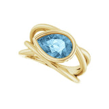 Criss-cross aquamarine cocktail ring in 10K yellow gold with pear-cut gemstone