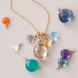 Custom 4 gemstone necklace in gold with mixed birthstones, flat lay