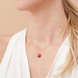 Minimal ruby pendant necklace with deep crimson sparkle on model variant--14K-rose-gold