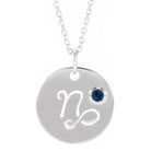 Capricorn zodiac medallion in 14K white gold with matching birthstone charm detail.