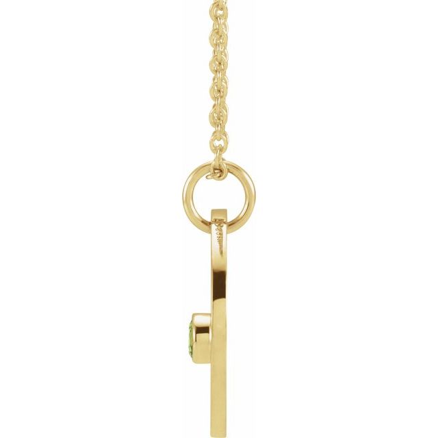 Dainty Gemini necklace with engraved charm and green peridot accent side view