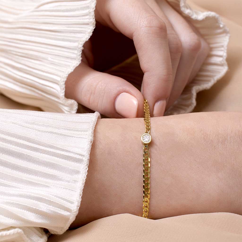 Dainty diamond bracelet in 14K gold with curb chain and lobster clasp show on wrist