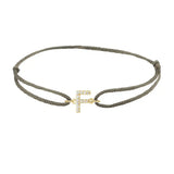 Diamond initial f silk bracelet in 14K yellow gold on olive silk