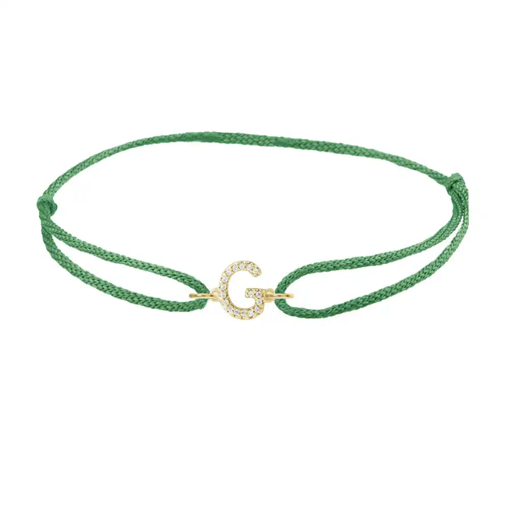 Diamond initial g silk bracelet in 14K yellow gold on emerald silk