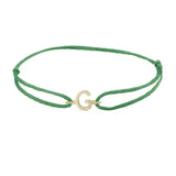 Diamond initial g silk bracelet in 14K yellow gold on emerald silk