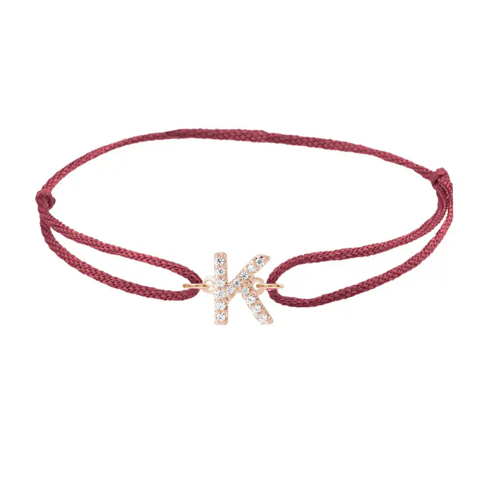 Diamond initial k silk bracelet in 14K rose gold on burgundy silk