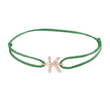 Diamond initial k silk bracelet in 14K rose gold on emerald silk
