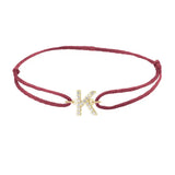 Diamond initial k silk bracelet in 14K yellow gold on burgundy silk