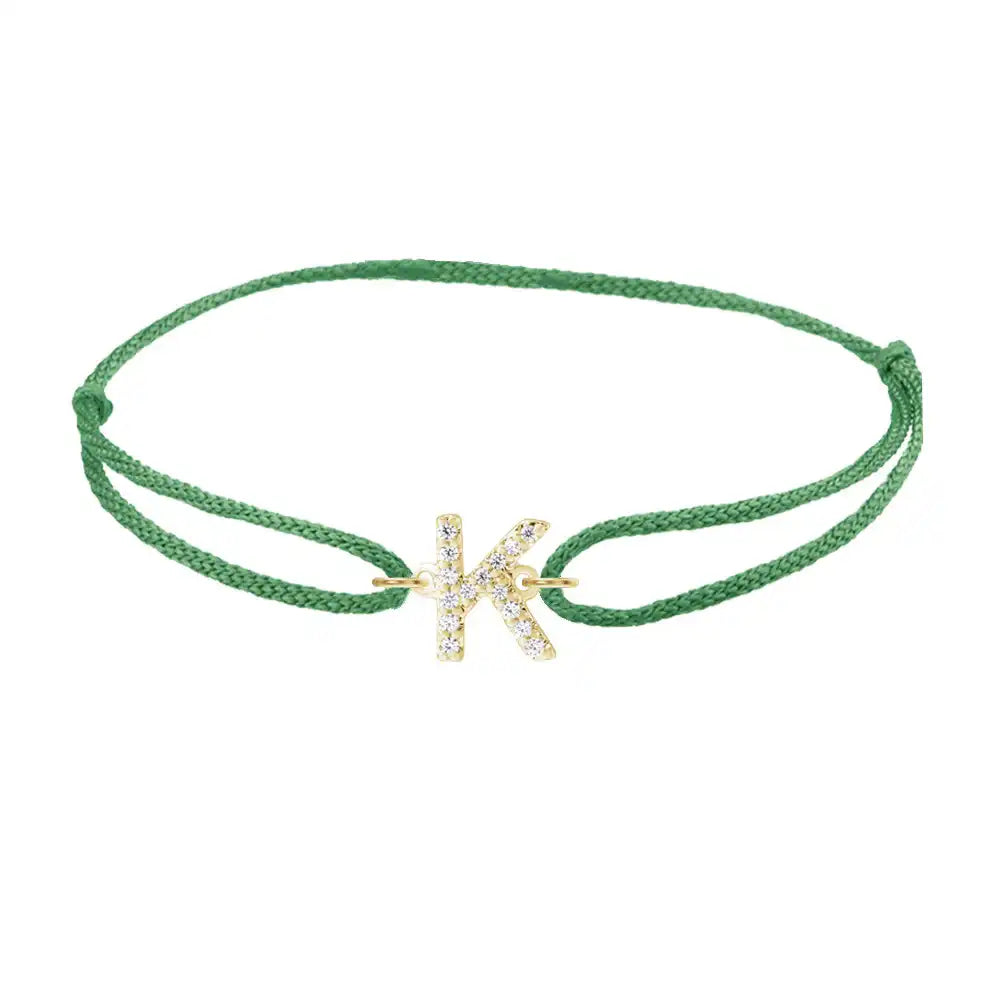 Diamond initial k silk bracelet in 14K yellow gold on emerald silk
