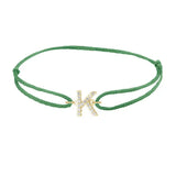 Diamond initial k silk bracelet in 14K yellow gold on emerald silk
