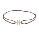 Diamond initial n silk bracelet in 14K yellow gold on brown silk