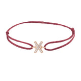 Diamond initial x silk bracelet in 14K rose gold on burgundy silk