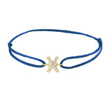 Diamond initial x silk bracelet in 14K yellow gold on blue silk