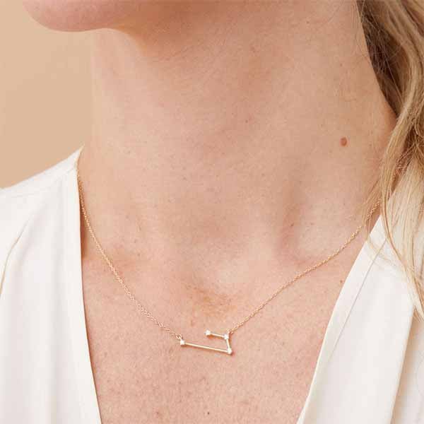 aries zodiac diamond necklace close up on model