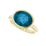 East-west London blue topaz ring in 10K gold, 11x9mm oval cut stone detail