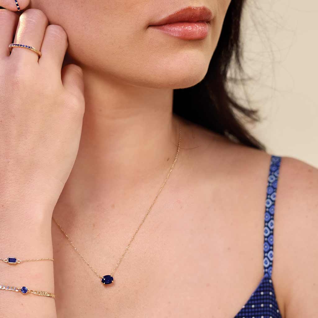 Oval turquoise prong-set necklace on fine gold chain on model variant--14K-yellow-gold