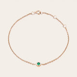 Bezel-set emerald bracelet in 14K rose gold, close-up of green stone in bezel rose gold variant--14K-rose-gold variant--Emerald