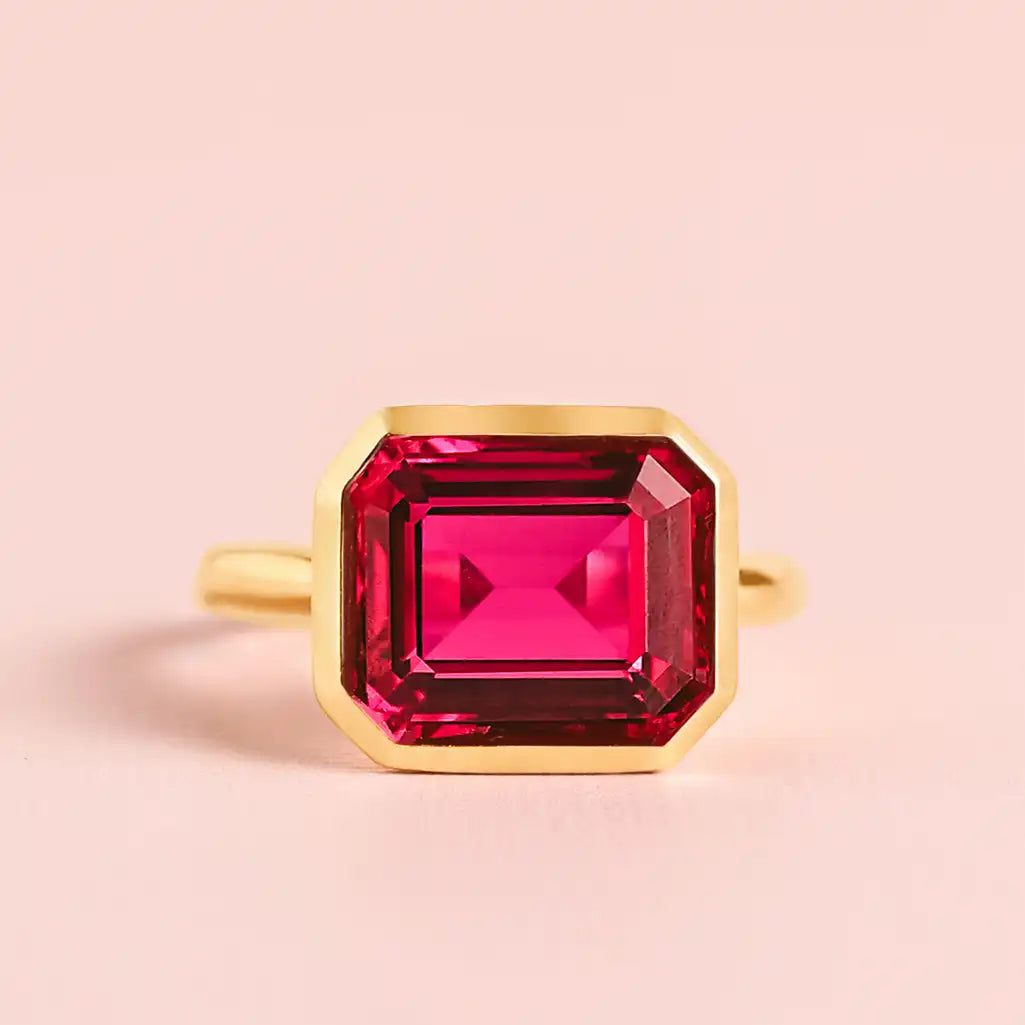 East-west emerald-cut ruby cocktail ring in 10K yellow gold, horizontal stone placement