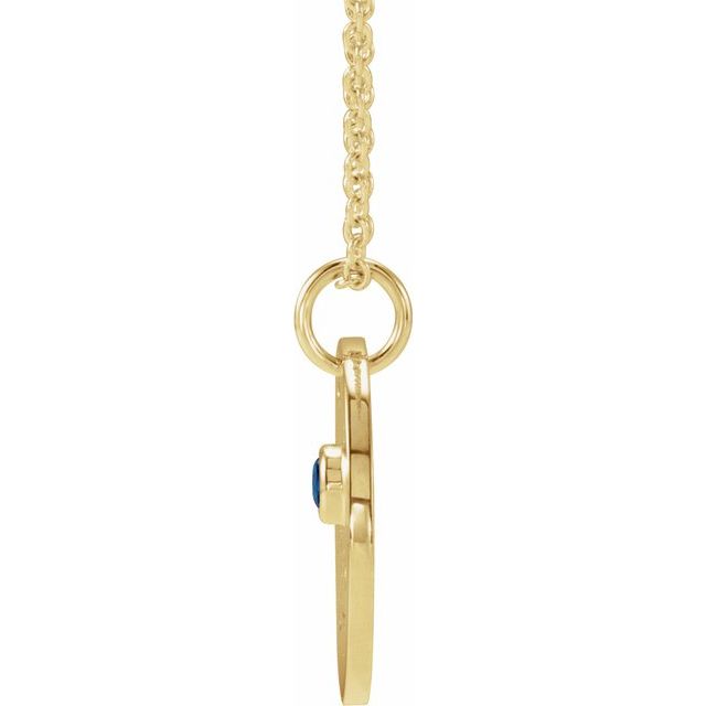 Hand-engraved Capricorn charm paired with sapphire gemstone on gold chain side view