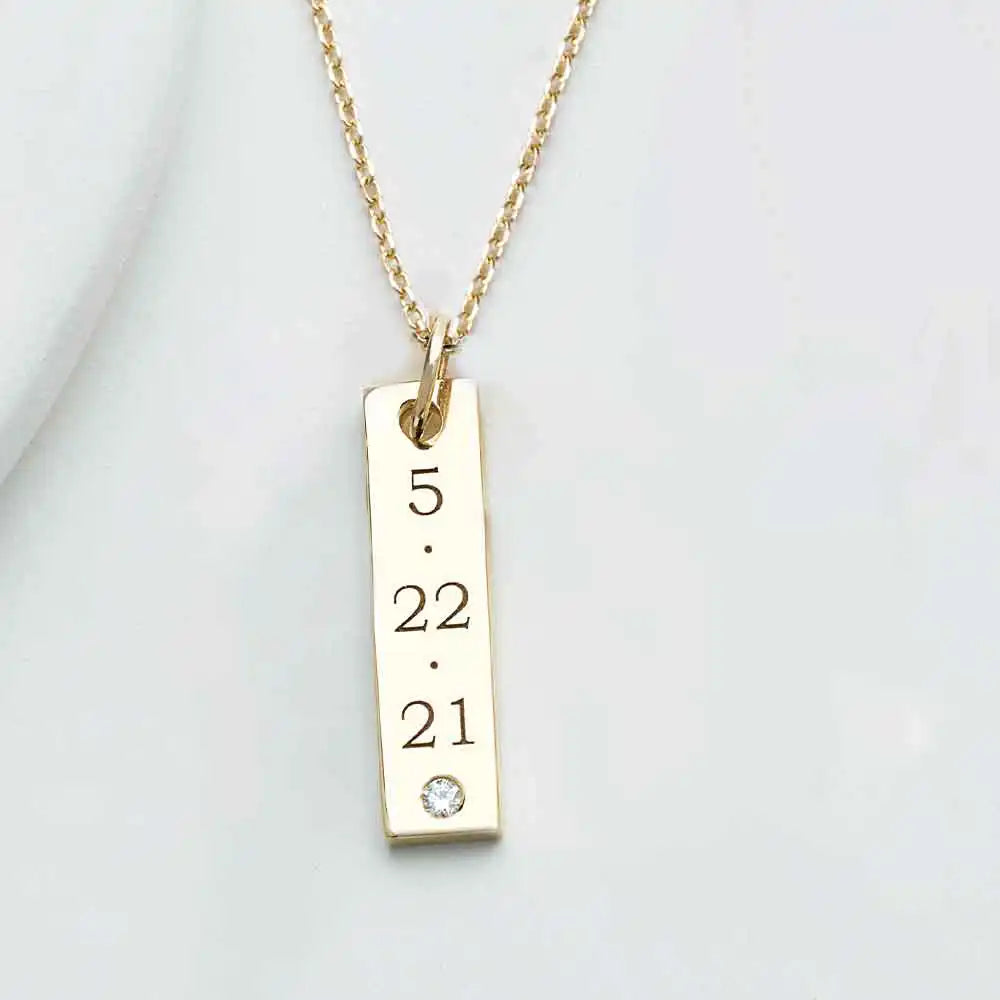 Date engraved on custom gold bar pendant with diamond accent