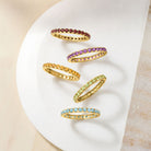 Macro shot of full eternity rings in different gemstones — close-up sparkle