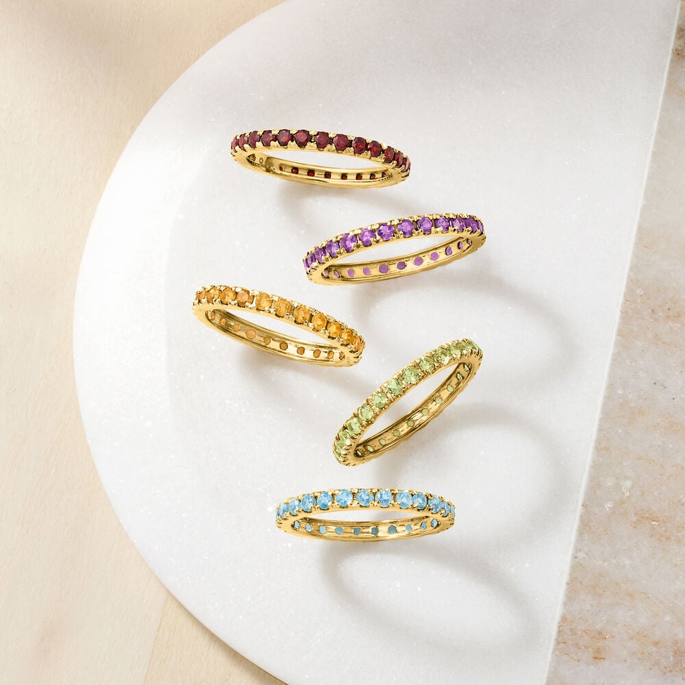 Macro shot of full eternity rings in different gemstones, close-up sparkle