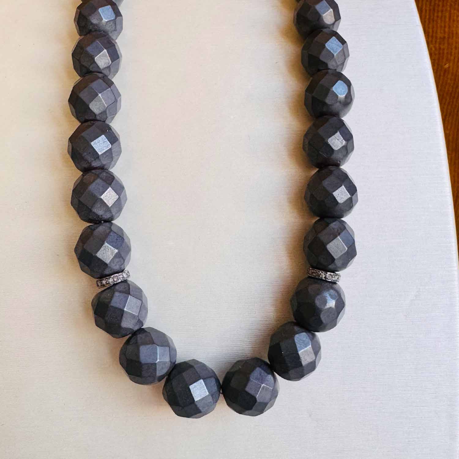 Hematite beaded necklace in gold-fill, close-up of metallic dark grey hematite beads variant--Hematite