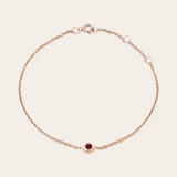 Bezel-set garnet bracelet in 14K rose gold, close-up of red stone in bezel rose gold variant--14K-rose-gold variant--Garnet