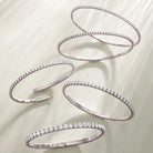 Luxury gift idea: flexible diamond bangles shown in white gold in various carat weights