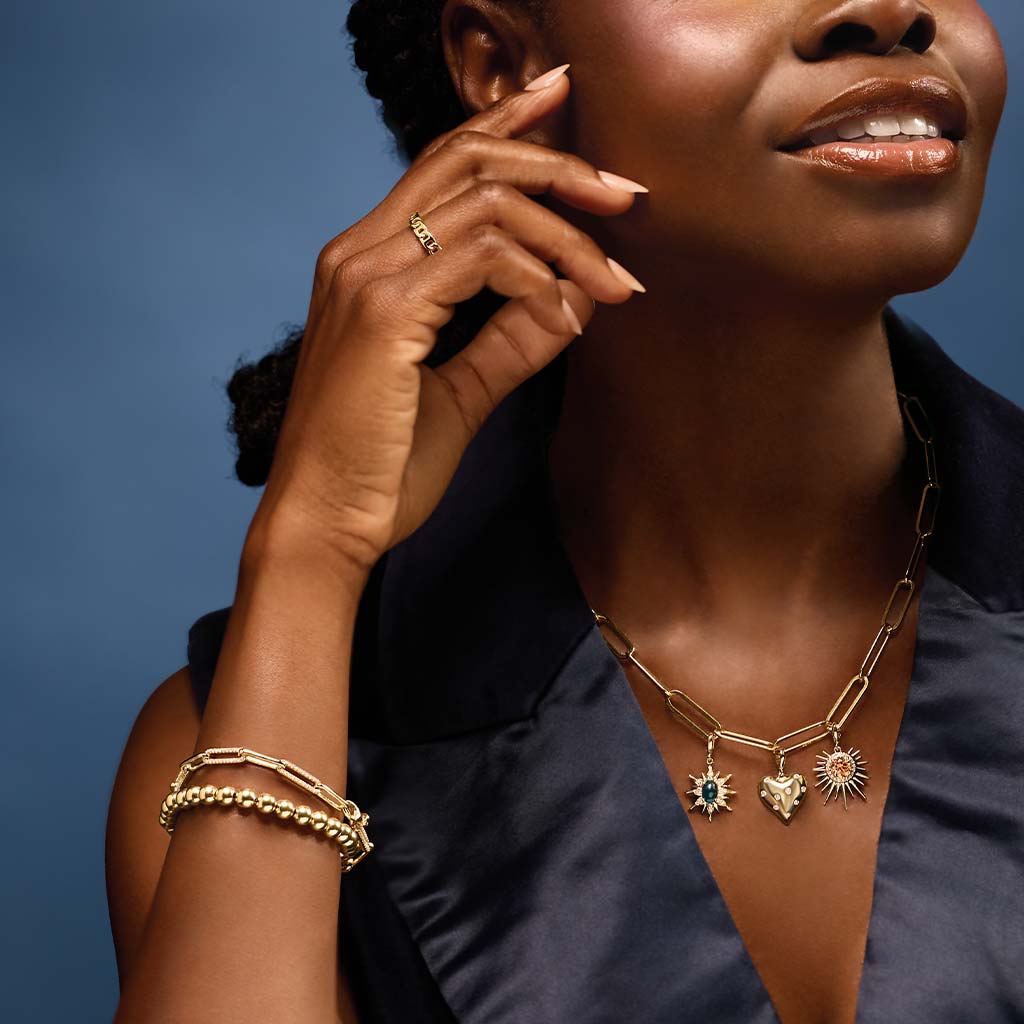 Gold diamond link bracelet stacked on model