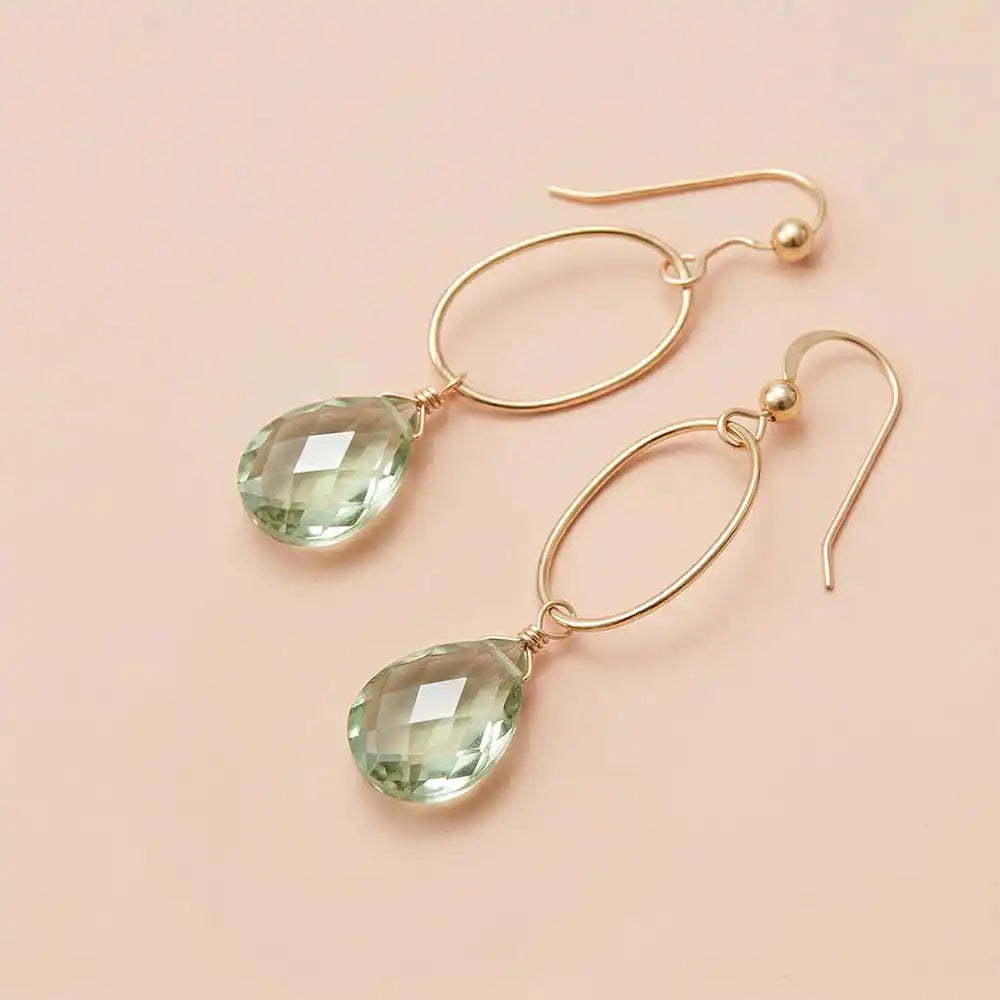 Faceted green amethyst drop earrings in yellow gold fill, pale mint-green gemstone teardrop briolette suspended from slim oval gold link, blush background. all-groups