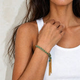 Green braided chain and silk tassel bracelet tied on the wrist