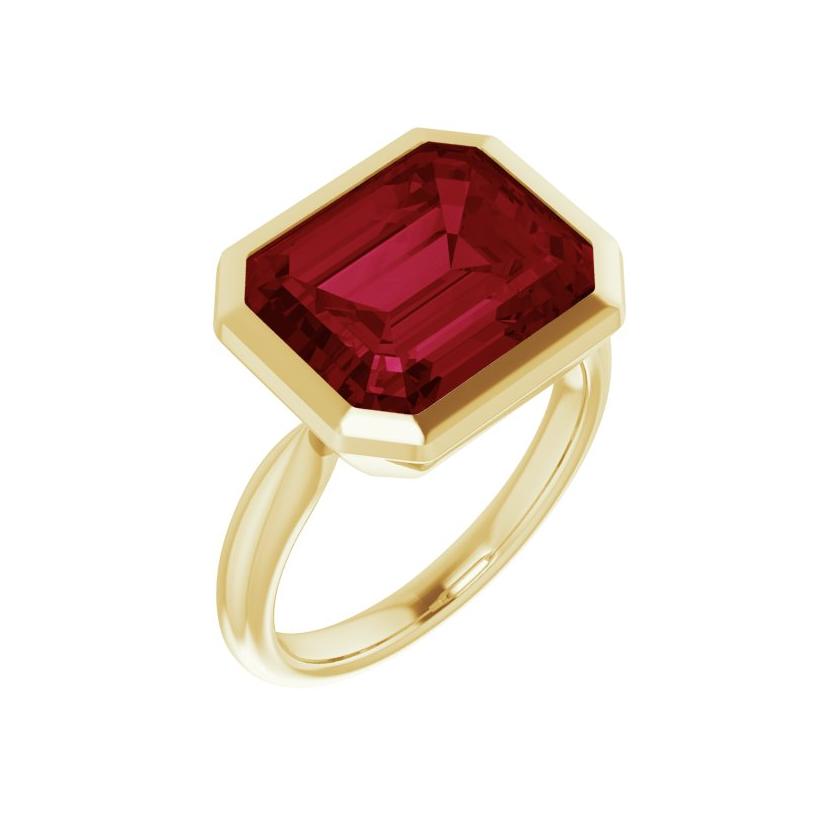 Bold east-west ruby ring with emerald-cut stone in eco-friendly recycled gold