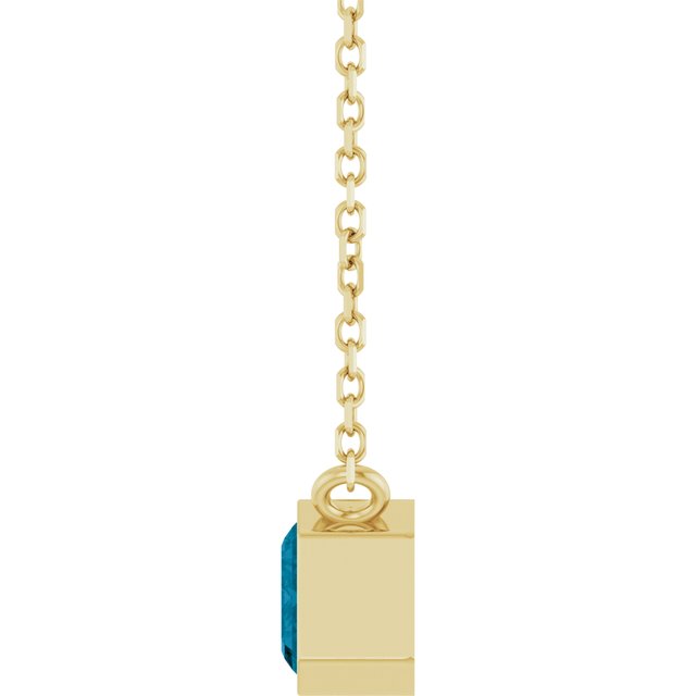 Horizontal emerald-cut topaz in moody blue tones side view
