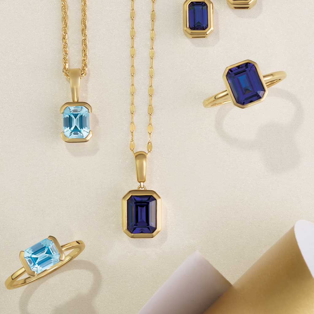 14k yellow gold keyhole chain necklace shown with sapphire pendant