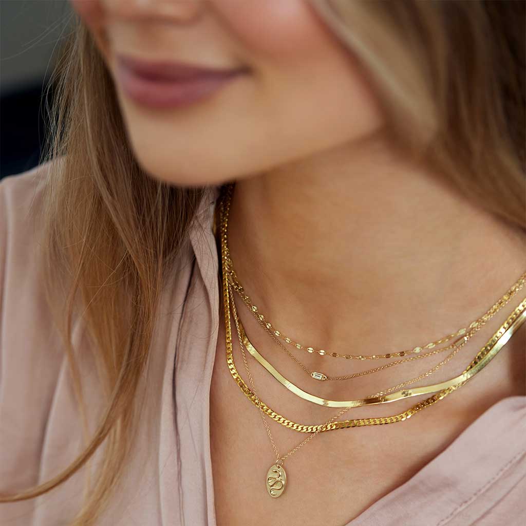 14k yellow gold keyhole chain layered style shown on model